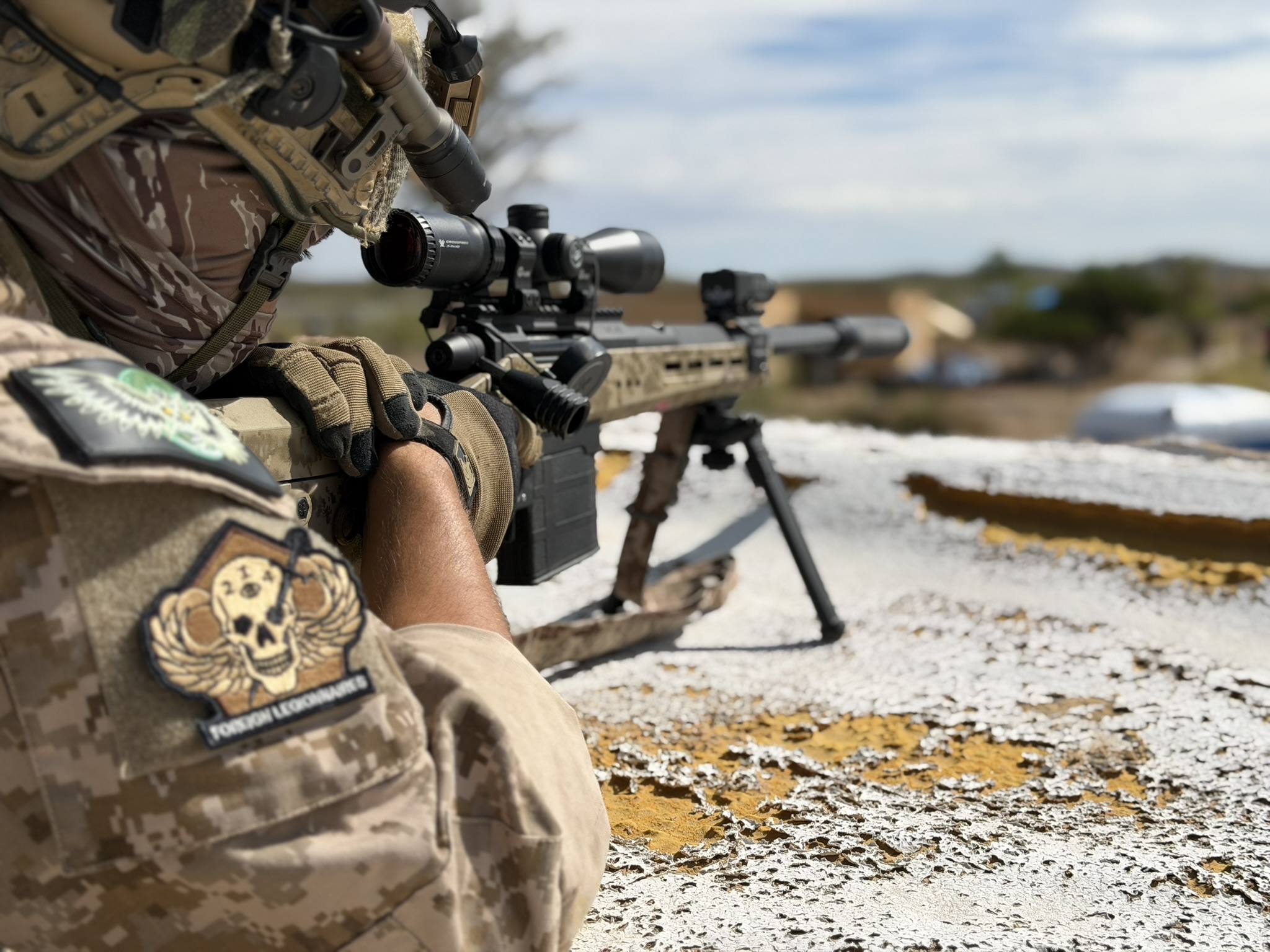 Close detail of a 214 Foreign Legionnaires patch on airsoft field gear.